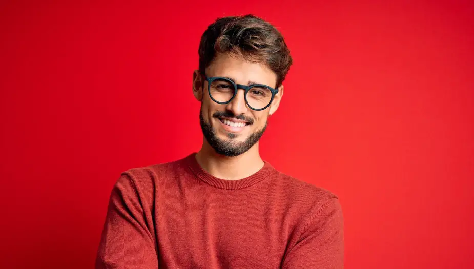 A man in glasses wearing red for his personality