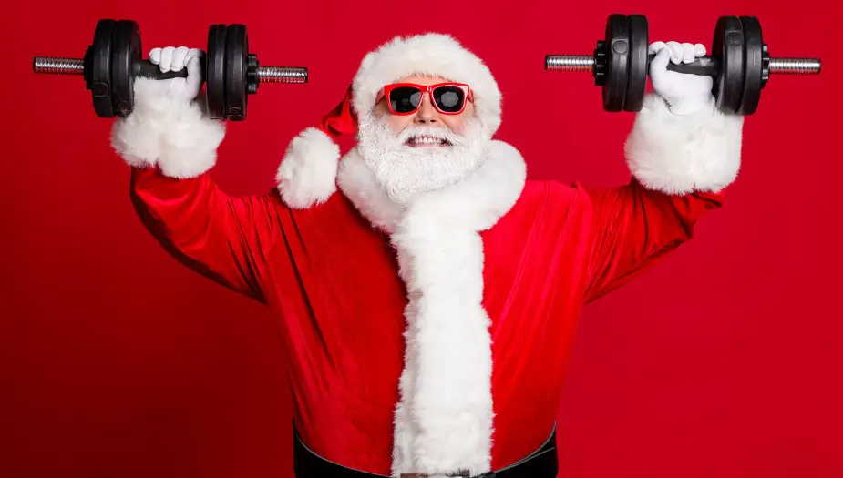 santa lifting in red strengths suit