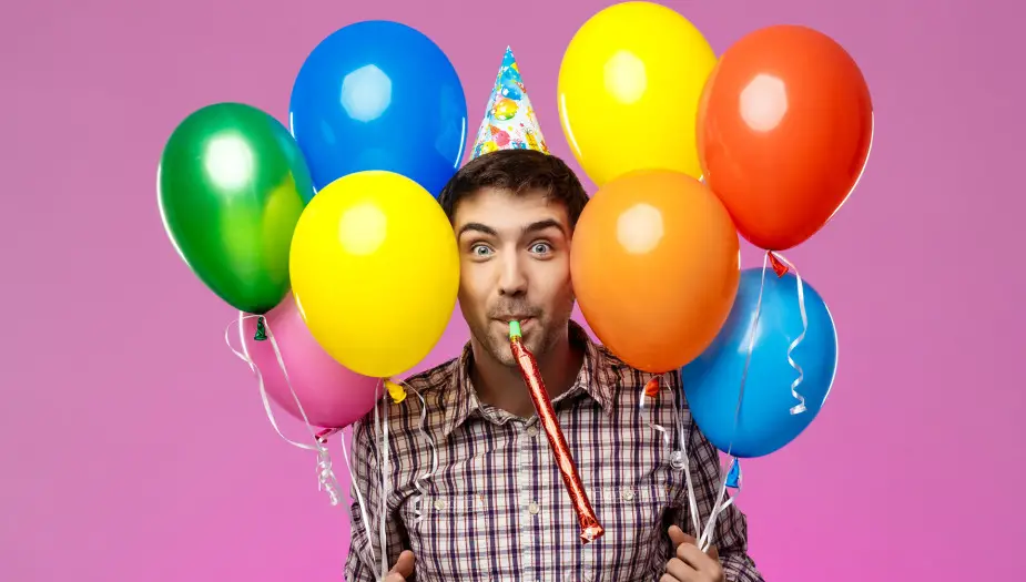 happy birthday man with color coded baloons