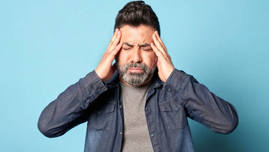 Man Seeming Depressed with Blue Background