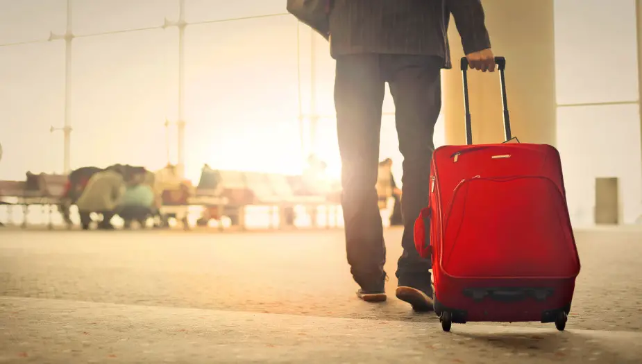 manipulating man with red suitcase