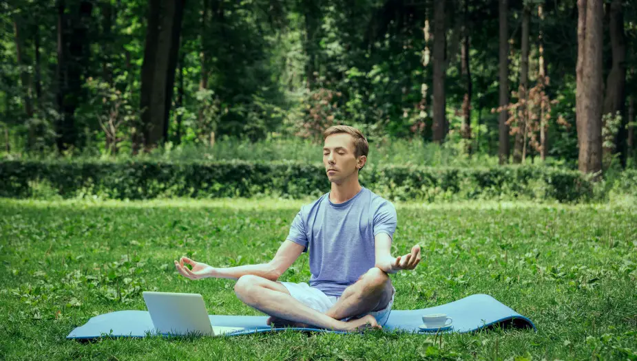 person on grass showing green calming effect